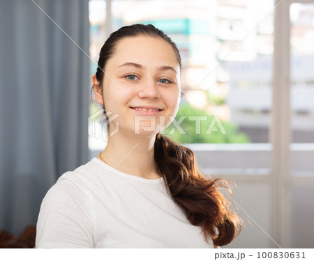 Smiling young housewife posing at home Smiling young housewife posing at home 100830631