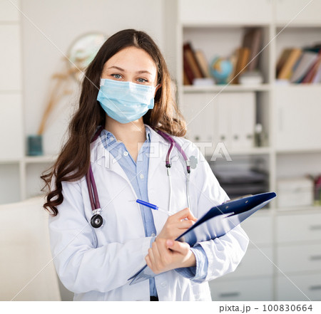 Woman doctor wear white medical uniform and stethoscope in mask Woman doctor wear white medical uniform and stethoscope in mask 100830664