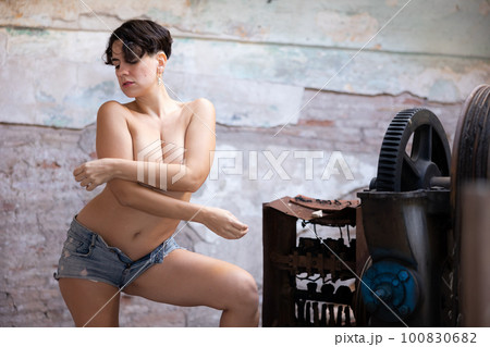Topless photo of woman in derelict factory 100830682