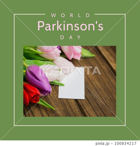 Composite of blank note and tulips on table with world parkinson's day text over green background 100834217