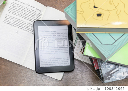 stacked books and ebook device 100841063