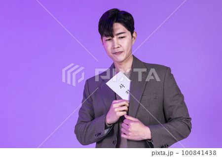 handsome Korean young man holding a letter of resignation handsome Korean young man holding a letter of resignation 100841438