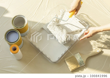 DIY interior hand motion, closeup_holding a paint roller DIY interior hand motion, closeup_holding a paint roller 100841996