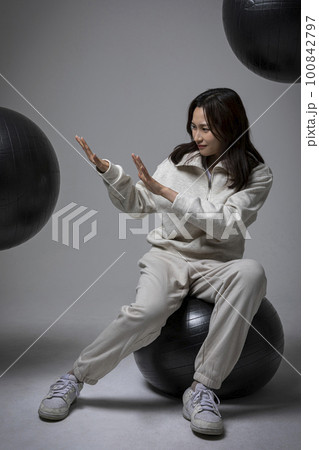 stressed, depressed Korean business woman in pink suit, exhausted 100842797