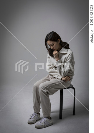 stressed, depressed Korean business woman in pink suit, worrying stressed, depressed Korean business woman in pink suit, worrying 100842828