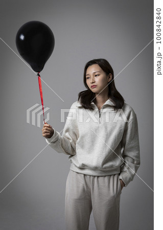stressed, depressed Korean business woman in pink suit, worrying 100842840