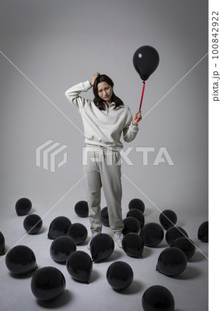 stressed, depressed Korean business woman in pink suit, worrying stressed, depressed Korean business woman in pink suit, worrying 100842922