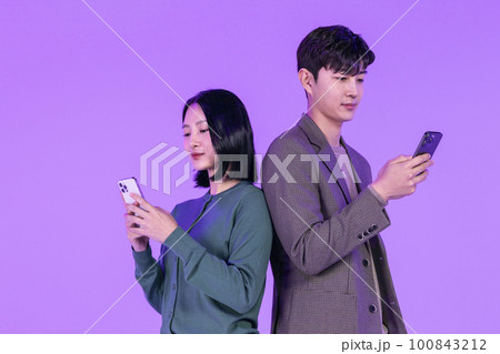 business working concept, young Korean Asian woman and man holding mobile phone with empty screen 100843212