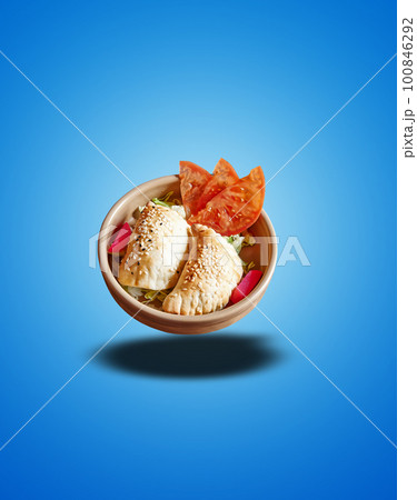 Floating  Black bowl with Sambusek apetizer  on blue gradient 100846292