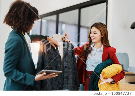 Multi ethnic young teen african american and asian woman fashion designer stylish and friend working at fashion Business studio. 100847727