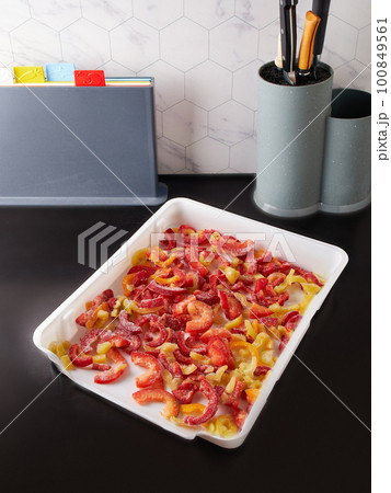 Smart storage of frozen food in trays. Dumplings, berries, peppers are convenient to prepare for the winter Smart storage of frozen food in trays. Dumplings, berries, peppers are convenient to prepare for the winter 100849561