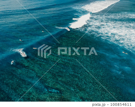 Aerial view with surfing on wave. Perfect waves with surfers in clear ocean 100854611