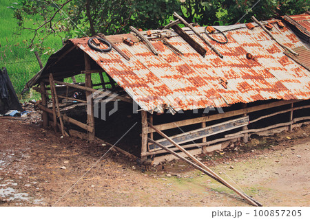 Old tin shed for the livestock at a farm in Kampot Cambodia showing the candid and authentic moment of rural life, cottagecore and slow living lifestyle 100857205