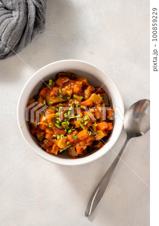 Vegetable stew, vegan healthy food in white bowl. Top view. Vegetable stew, vegan healthy food in white bowl. Top view. 100859229