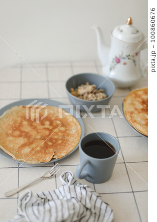Stack of crepes on kitchen table. Pancakes for breakfast, food photography Stack of crepes on kitchen table. Pancakes for breakfast, food photography 100860676