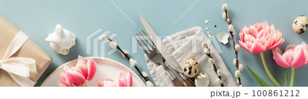Banner. Easter table setting with white plate, spring flowers and cutlery. Holidays background Banner. Easter table setting with white plate, spring flowers and cutlery. Holidays background 100861212