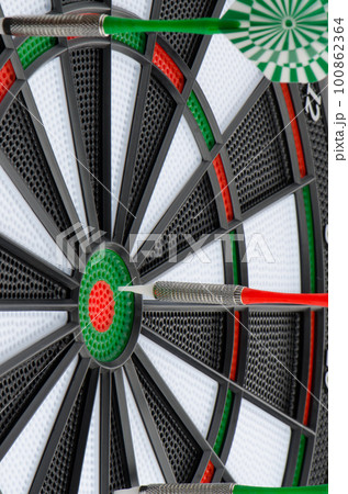 Dart board with darts Dart board with darts 100862364