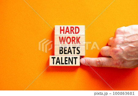 Hard work beats talent symbol. Concept words Hard work beats talent on wooden block. Beautiful orange table orange background. Motivational business hard work beats talent concept. Copy space. 100863681