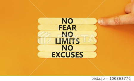 No fear limits excuses symbol. Concept words No fear no limits no excuses on wooden stick. Beautiful orange background. Businessman hand. Business not fear limits excuses concept. Copy space. 100863776