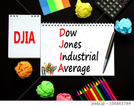 DJIA Dow Jones industrial average symbol. Concept words DJIA Dow Jones industrial average on white note on beautiful black background. Business DJIA Dow Jones industrial average concept. Copy space 100863799