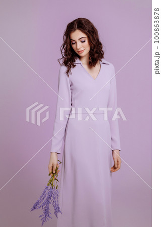 Attractive woman with bouquet on lilac background Attractive woman with bouquet on lilac background 100863878