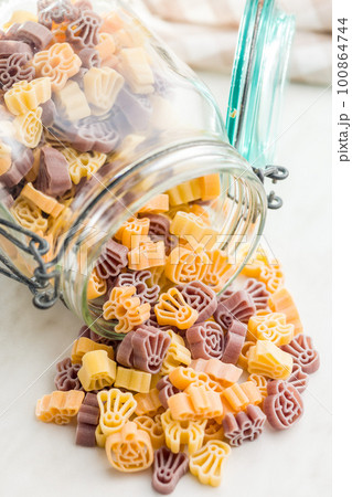 Pasta of various scary shapes. Uncooked halloween pasta in jar. Pasta of various scary shapes. Uncooked halloween pasta in jar. 100864744