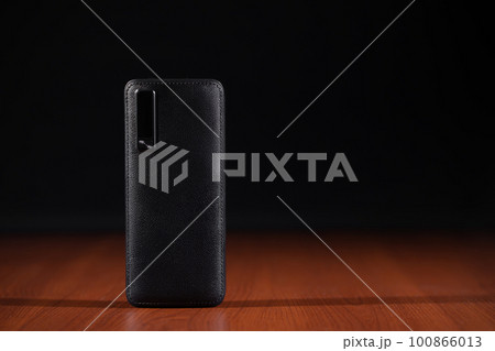 black power bank for charging mobile devices on black background black power bank for charging mobile devices on black background 100866013