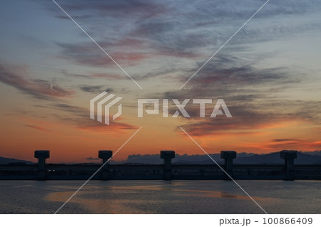 多彩に朝焼けした空と映り込む川・春・230301am 100866409