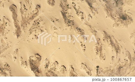 Aerial View of the Textures and Patterns of the Desert Sands. Beautiful landscape . Desert and green bushes Aerial View of the Textures and Patterns of the Desert Sands. Beautiful landscape . Desert and green bushes 100867657