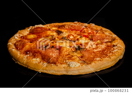 Burnt homemade pizza on tray in electric oven, black background Burnt homemade pizza on tray in electric oven, black background 100868231