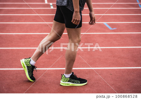 陸上競技のトラックでスタートを切る男性ランナー 100868528
