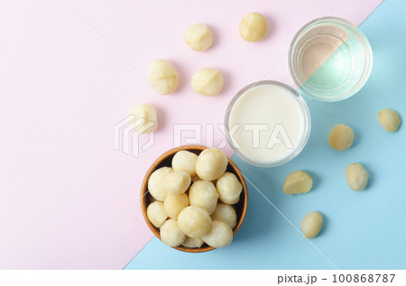 The Macadamia milk and Macadamia oil in glass on beautiful background. The Macadamia milk and Macadamia oil in glass on beautiful background. 100868787