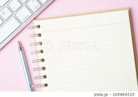 The Open blank notebook and pen with keyboard computer on pink color background. 100869220