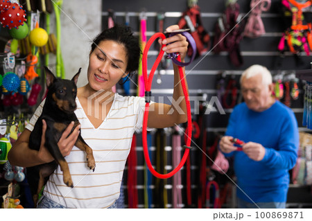 Woman with her dog in pet shop 100869871