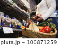 Picture of woman at marketplace buying vegetables 100871259