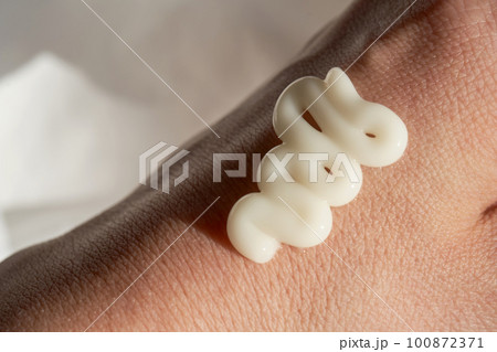 Photo of the texture of a moisturizing cream on the hand. 100872371