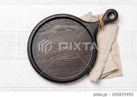 Wooden cutting board and kitchen towel 100875495