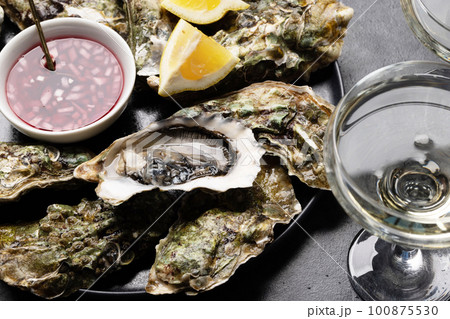 Fresh oysters with glasses of sparkling wine Fresh oysters with glasses of sparkling wine 100875530