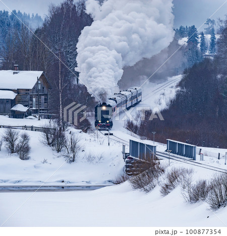 Retro steam train moves at winter morning time. Retro steam train moves at winter morning time. 100877354