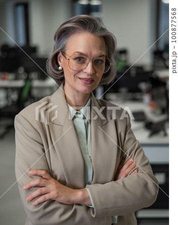 Portrait of an attractive mature caucasian woman with arms crossed on her chest in the office. Portrait of an attractive mature caucasian woman with arms crossed on her chest in the office. 100877568