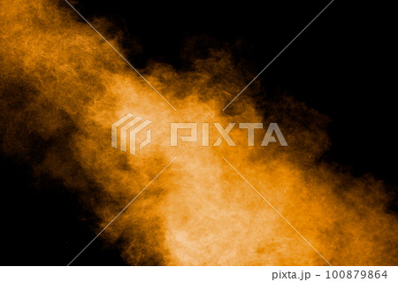Abstract explosion of orange dust on black background.Freeze motion of orange powder burst. Abstract explosion of orange dust on black background.Freeze motion of orange powder burst. 100879864