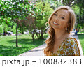 Happy blond woman relaxing in a public park 100882383