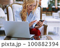 Businesswoman using smartphone in the modern bank lobby 100882394