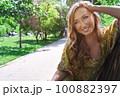 Happy blond woman relaxing in a public park 100882397