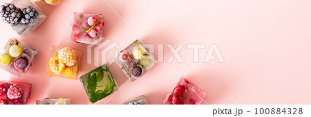 Frozen ice cubes with various berries Frozen ice cubes with various berries 100884328