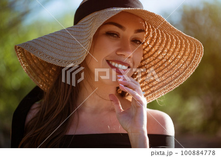 Beautiful woman in a hat on nature close-up Beautiful woman in a hat on nature close-up 100884778