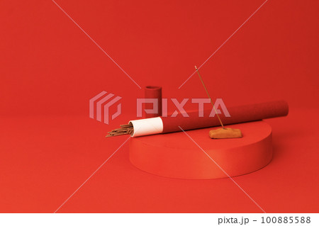 Red round pedestal with an aroma sticks package. Fragrant Indian snuff sticks and smell smoke coming out. Red round pedestal with an aroma sticks package. Fragrant Indian snuff sticks and smell smoke coming out. 100885588