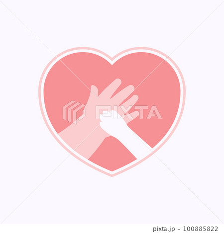 Paw on hand of kid in heart shaped frame 100885822