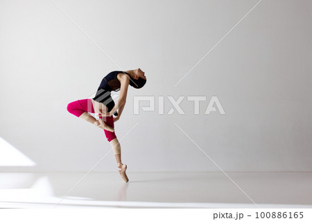 Young and graceful ballet dancer isolated over white background. Flexible ballerina, weightless jumps 100886165