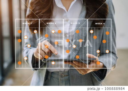 Business woman hand Project manager working and update tasks and Gantt chart scheduling virtual diagram.with tablet in office. Business woman hand Project manager working and update tasks and Gantt chart scheduling virtual diagram.with tablet in office. 100888984